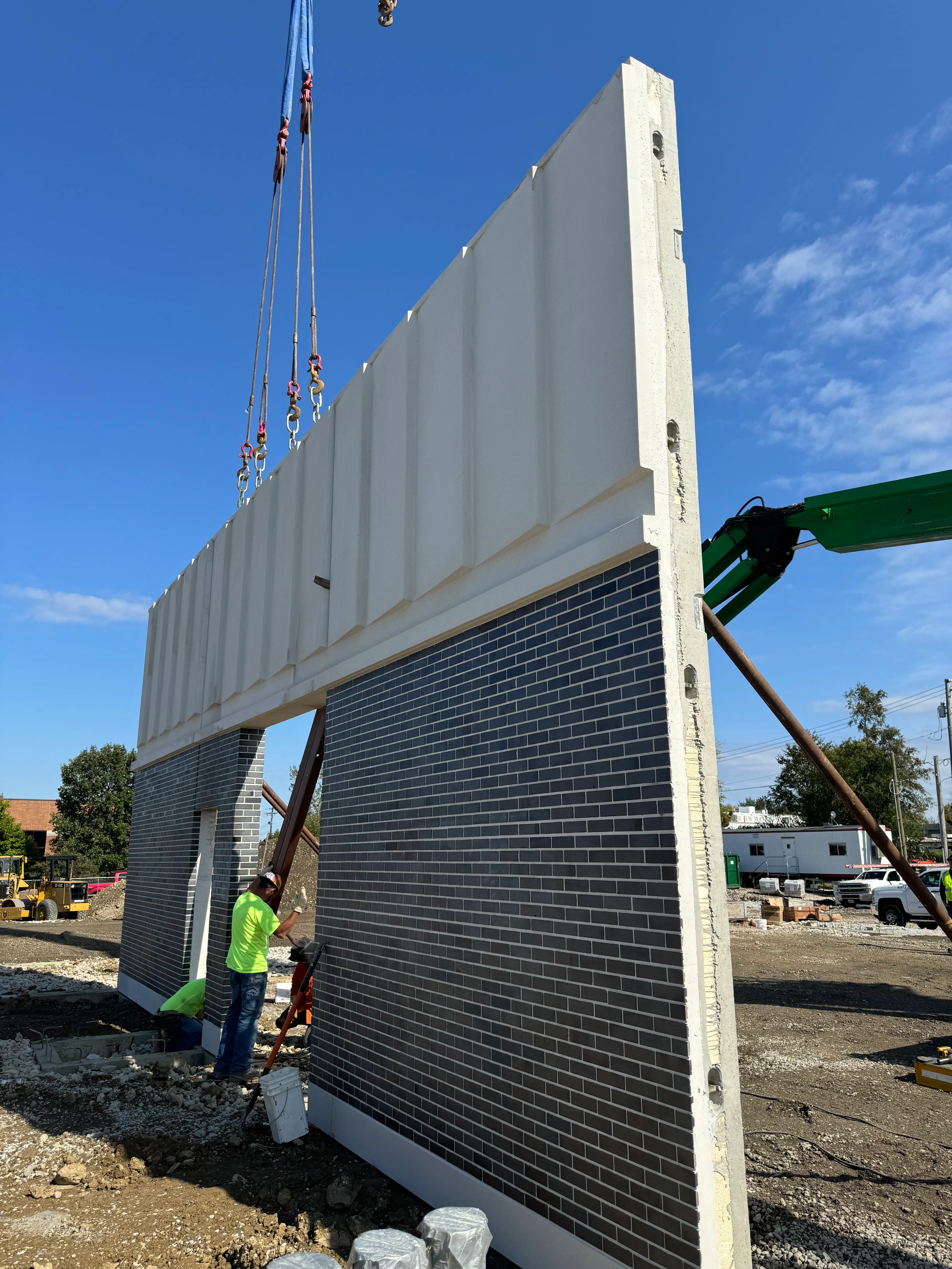 Prestressed concrete bridge girder being lifted into place by crane on an Illinois highway project