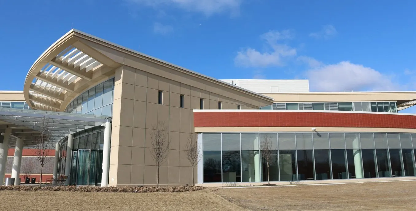 Entrance canopy and precast roof edge at the Lake Forest pavilions, with a red brick-faced precast band above continuous glazing