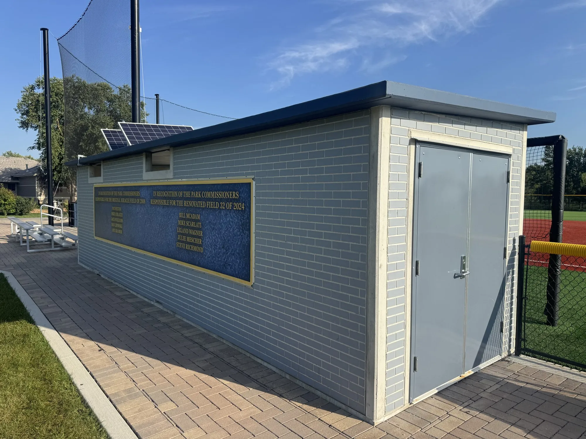 Dedication plaque on the precast dugout wall naming the park commissioners for the 2008 Miracle Field and the 2024 Field 32