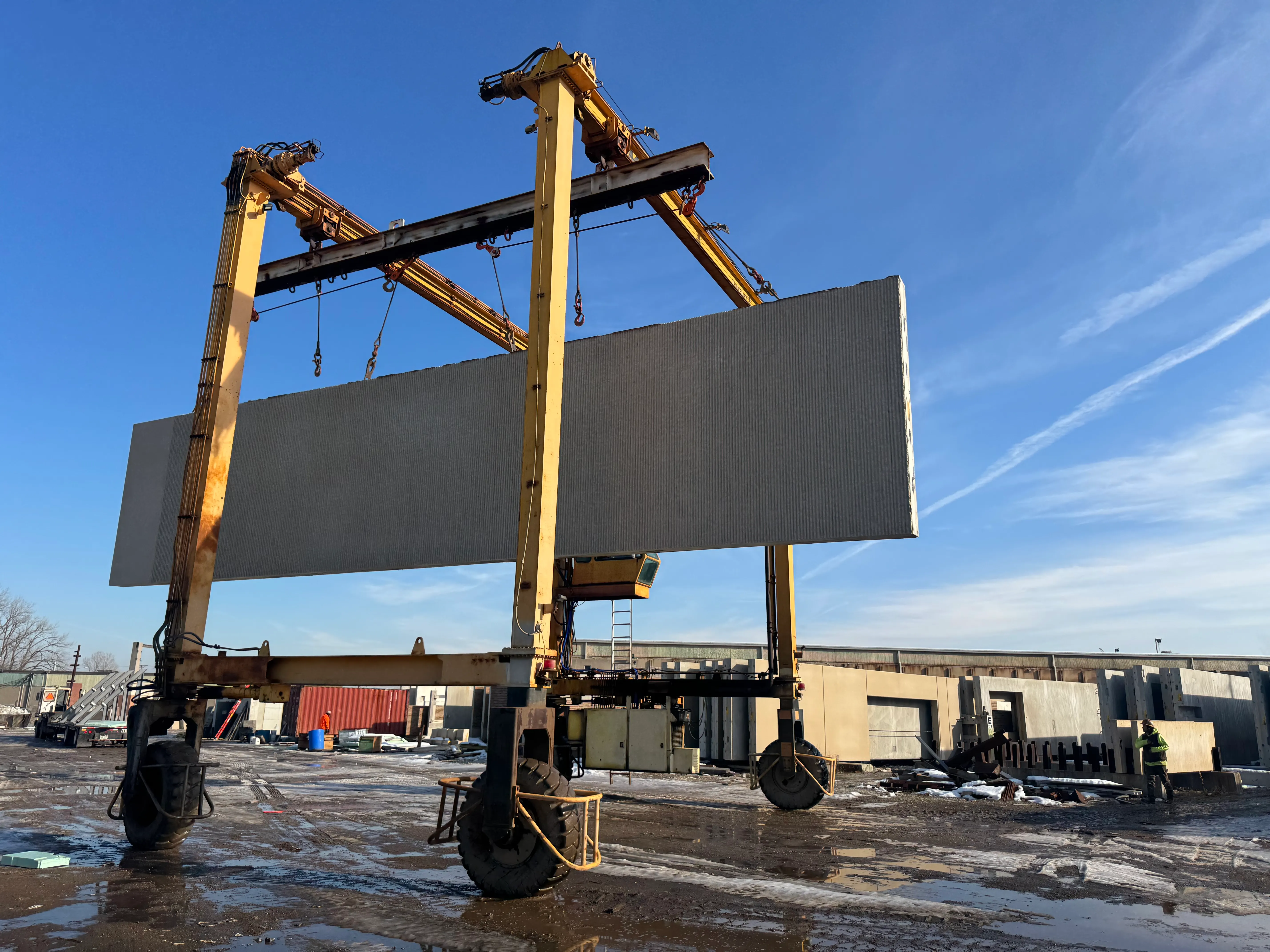 A crew moving precast panels in a producer's yard