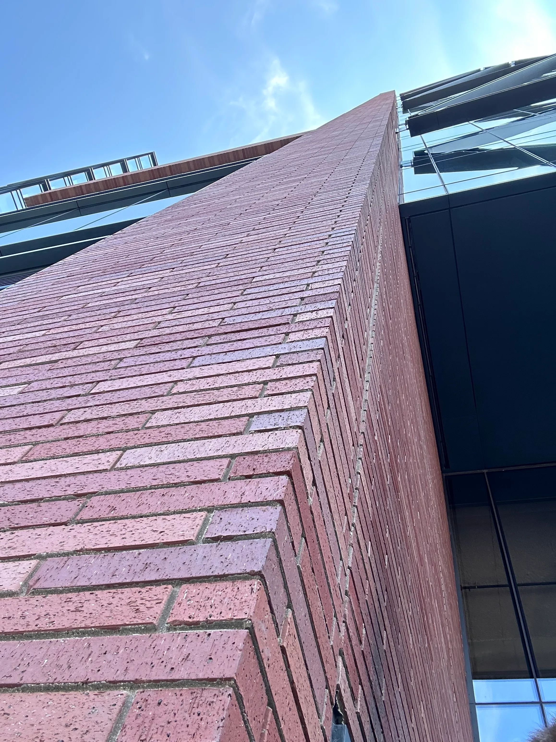 Corrugated formliner texture on an architectural precast panel, raking light across the ribs